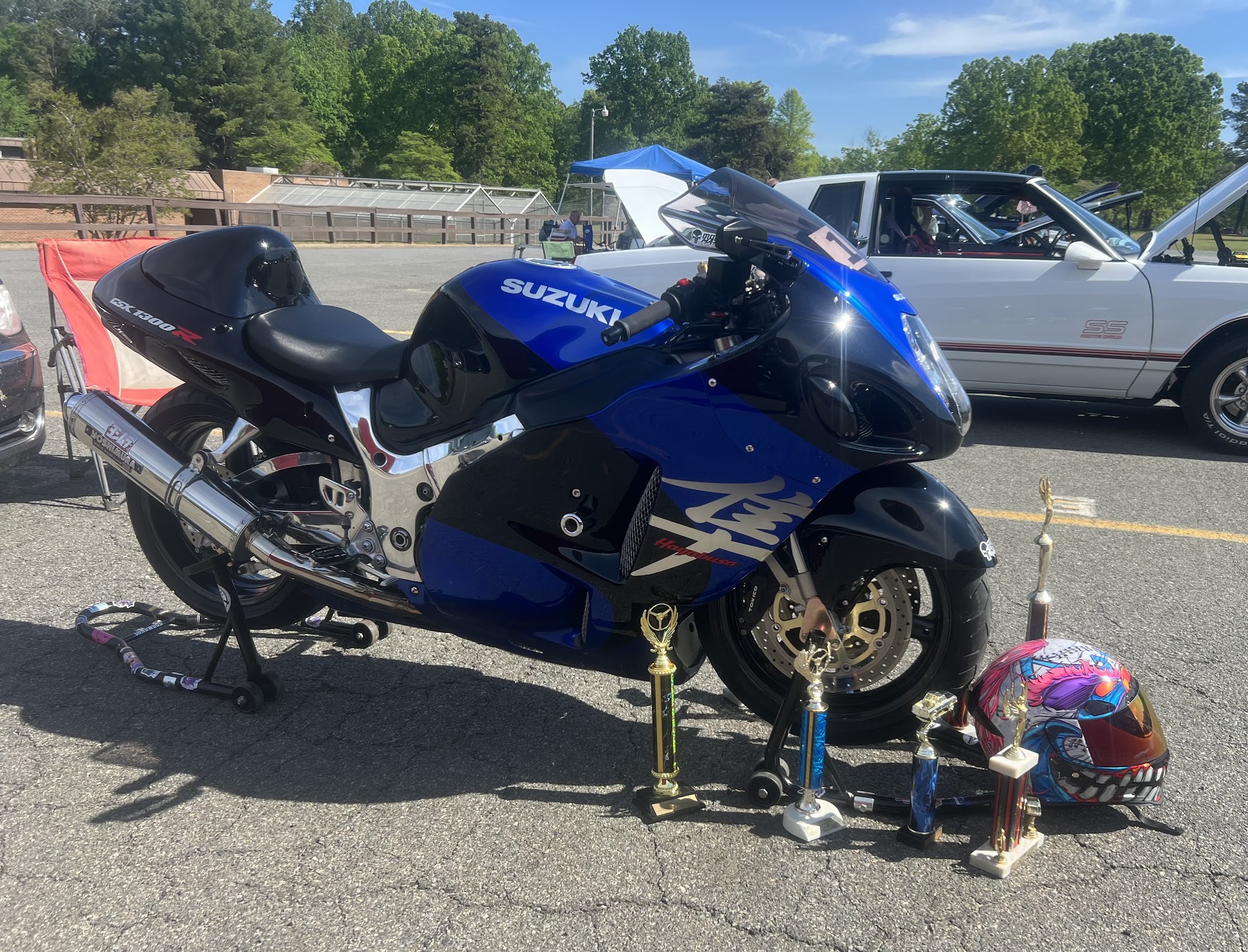 Blue Suzuki Hayabusa GSX1300R with trophies at a car and bike show