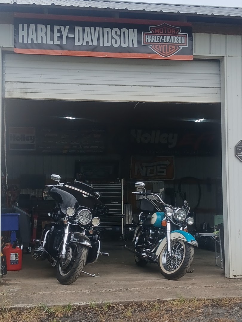 Buffalo Repair shop exterior with two Harley-Davidsons parked in the open bay under a Harley-Davidson banner